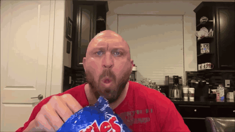 bald guy eating chips GIF